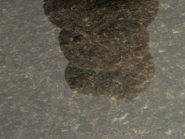 The factory (done when the slabs are first cut) Polish finish shown on a piece of Ubatuba granite